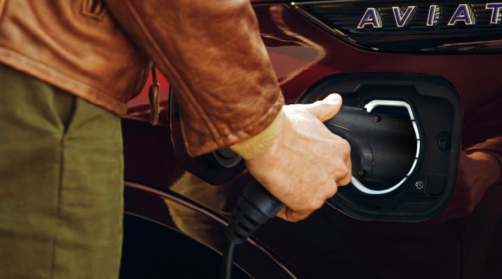 A hand is shown plugging in the charger into the charging port of a 2021 Lincoln Aviator | Spitzer Lincoln DuBois in Du Bois PA