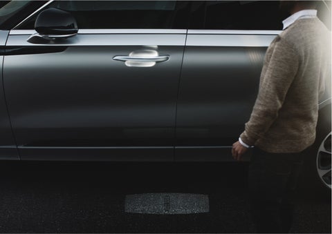 A person approaches a 2023 Lincoln Aviator® Grand Touring as the Lincoln Embrace sequence of welcome lighting illuminates | Spitzer Lincoln DuBois in Du Bois PA