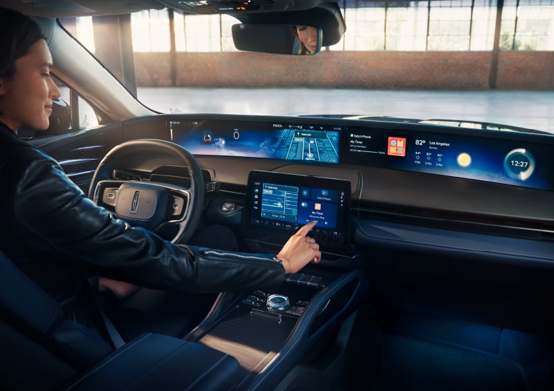 The driver of a 2024 Lincoln Nautilus® SUV interacts with the center touchscreen. | Spitzer Lincoln DuBois in Du Bois PA