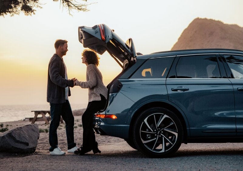 A couple share a moment together outside a 2025 Lincoln Corsair® SUV near the open liftgate. | Spitzer Lincoln DuBois in Du Bois PA