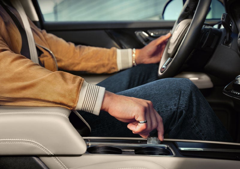 The driver of a 2024 Lincoln Corsair® SUV is shown selecting the drive mode. | Spitzer Lincoln DuBois in Du Bois PA