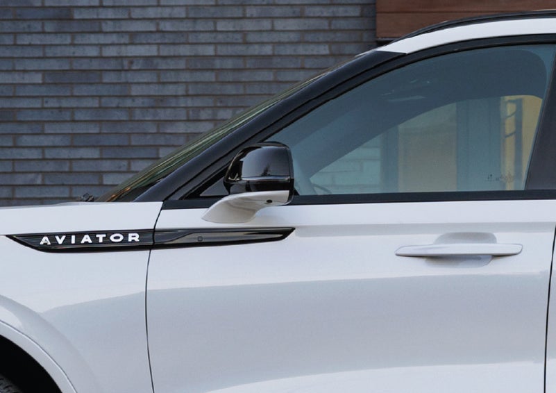 The driver’s side door and fender badging of a white 2026 Lincoln Aviator® SUV are showcased. | Spitzer Lincoln DuBois in Du Bois PA