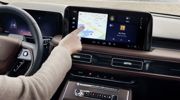 A person is tapping the center display touchscreen of a 2026 Lincoln Aviator® SUV. | Spitzer Lincoln DuBois in Du Bois PA