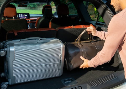 A man loads luggage into the rear of a 2026 Lincoln Aviator® SUV through the opened rear liftgate. | Spitzer Lincoln DuBois in Du Bois PA
