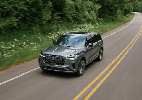 A 2027 Lincoln Aviator® SUV is being driven down a road. | Spitzer Lincoln DuBois in Du Bois PA