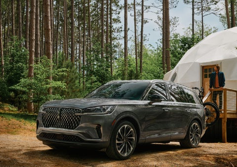 A 2027 Lincoln Aviator® is parked next to a high end glamping site. | Spitzer Lincoln DuBois in Du Bois PA