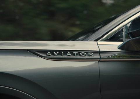 The driver’s side door and fender badging of a gray 2027 Lincoln Aviator® SUV are showcased. | Spitzer Lincoln DuBois in Du Bois PA