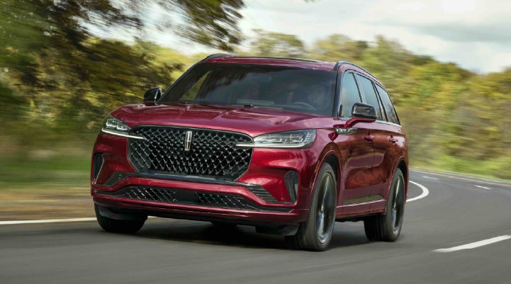 A 2027 Lincoln Aviator® SUV is being driven on a country road | Spitzer Lincoln DuBois in Du Bois PA