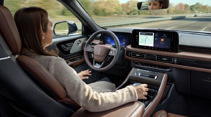 A 2027 Lincoln Aviator® SUV is being driven hands-free on a highway lined with trees. | Spitzer Lincoln DuBois in Du Bois PA