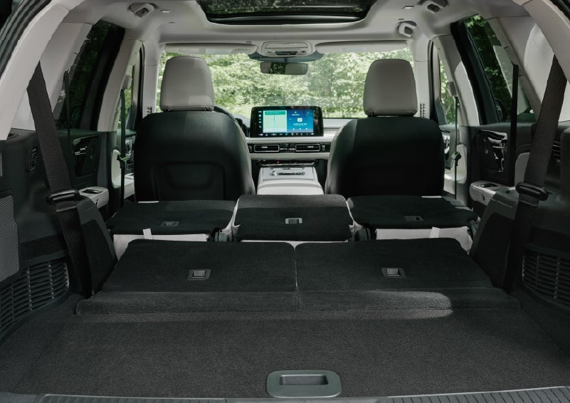 A rear to front view of the interior of a 2027 Lincoln Aviator® Black Label™ SUV shows the third and second rows folded flat | Spitzer Lincoln DuBois in Du Bois PA