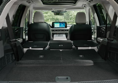 A rear to front view of the interior of a 2027 Lincoln Aviator® Black Label™ SUV shows the third and second rows folded flat | Spitzer Lincoln DuBois in Du Bois PA