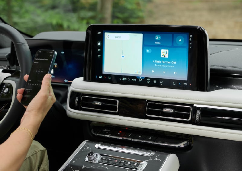 A person pairs thier phone with the center touchscreen of a 2027 Lincoln Aviator® Black Label™ SUV | Spitzer Lincoln DuBois in Du Bois PA